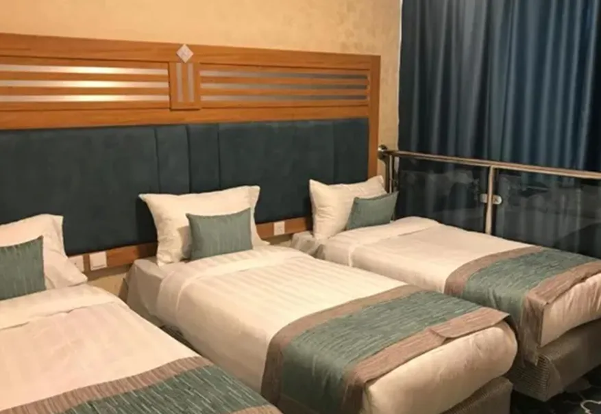 /media/umrah-images/room-with-3-single-beds%20%282%29.webp